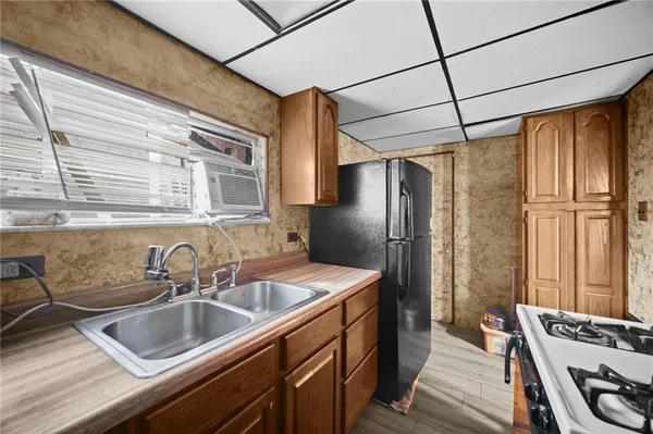 a kitchen that has a sink cabinets counter space and stainless steel appliances