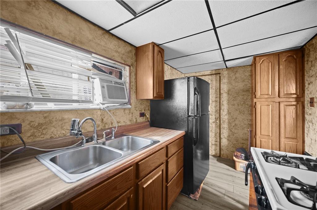 1412 Broadway Avenue McKees Rocks, PA 15136 - Photo 10 of 39 a kitchen that has a sink cabinets counter space and stainless steel appliances