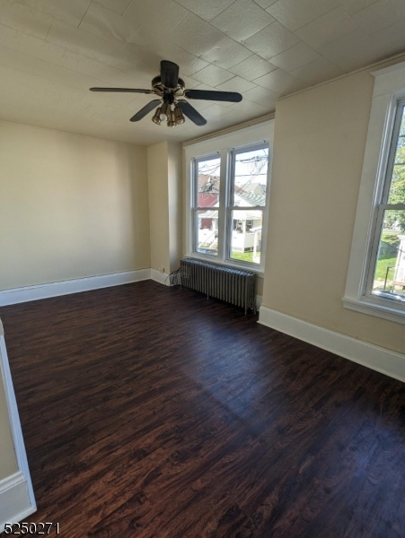 190 Chambers Street, Unit 2 Phillipsburg, NJ 08865 - Photo 2 of 10 an empty room with wooden floor fan and windows