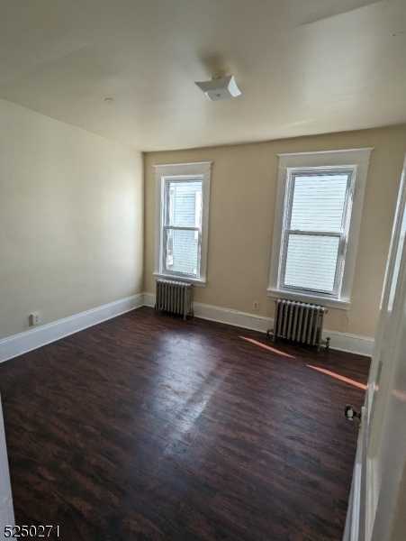 190 Chambers Street, Unit 2 Phillipsburg, NJ 08865 - Photo 3 of 10 an empty room with wooden floor and windows