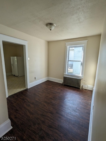 190 Chambers Street, Unit 2 Phillipsburg, NJ 08865 - Photo 4 of 10 an empty room with wooden floor and windows