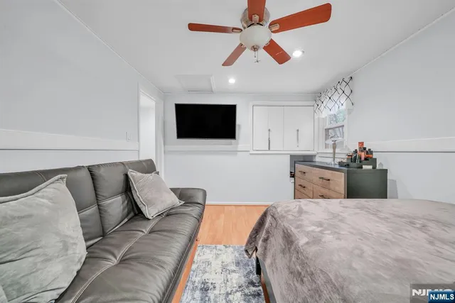 a bedroom with a large bed and a flat screen tv