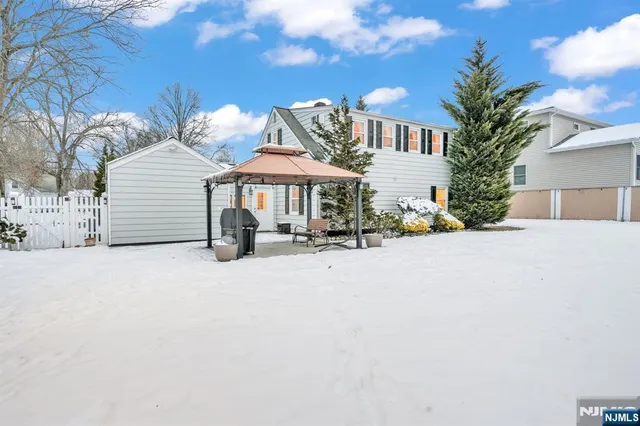 a view of a house with a yard and sitting area