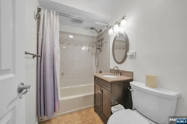 a bathroom with a toilet a sink and a mirror