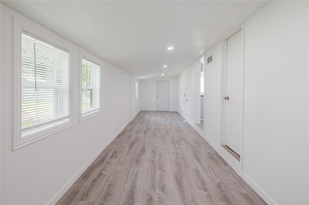 524 West Roberts Street Gorman, TX 76454 - Photo 31 of 35 a view of a big room with wooden floor and windows