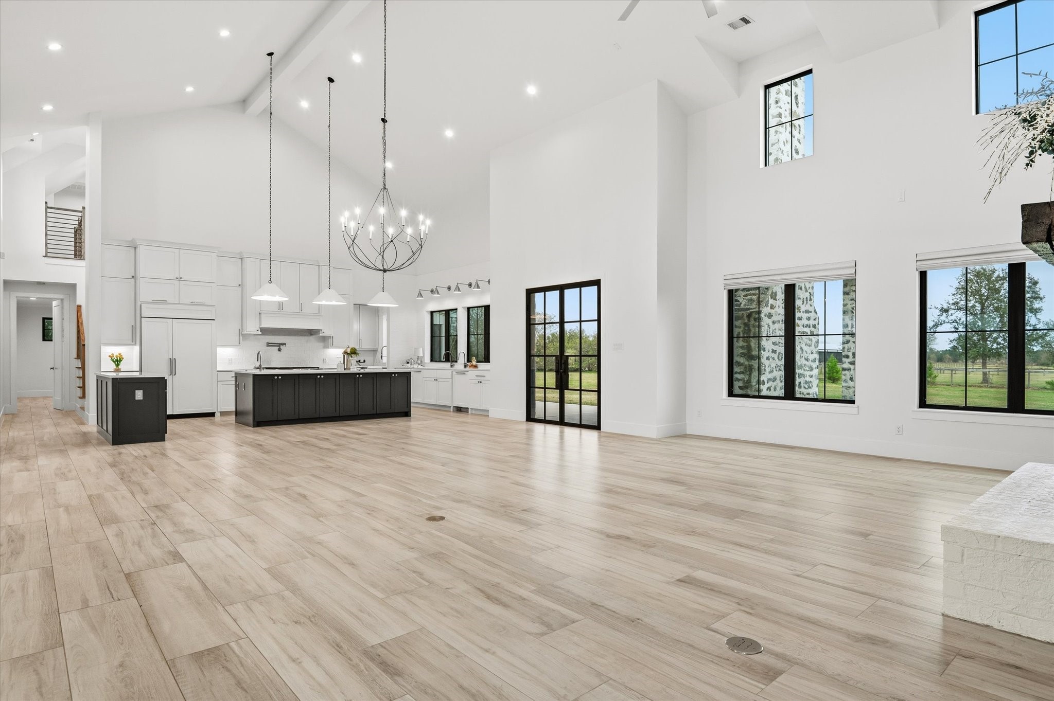 24118 Margerstadt Road Hockley, TX 77447 - Photo 12 of 50 Soaring vaulted ceilings and wide-plank tile flooring create a light-filled living space anchored by a gas-log-ready wood-burning fireplace and open sightlines throughout.