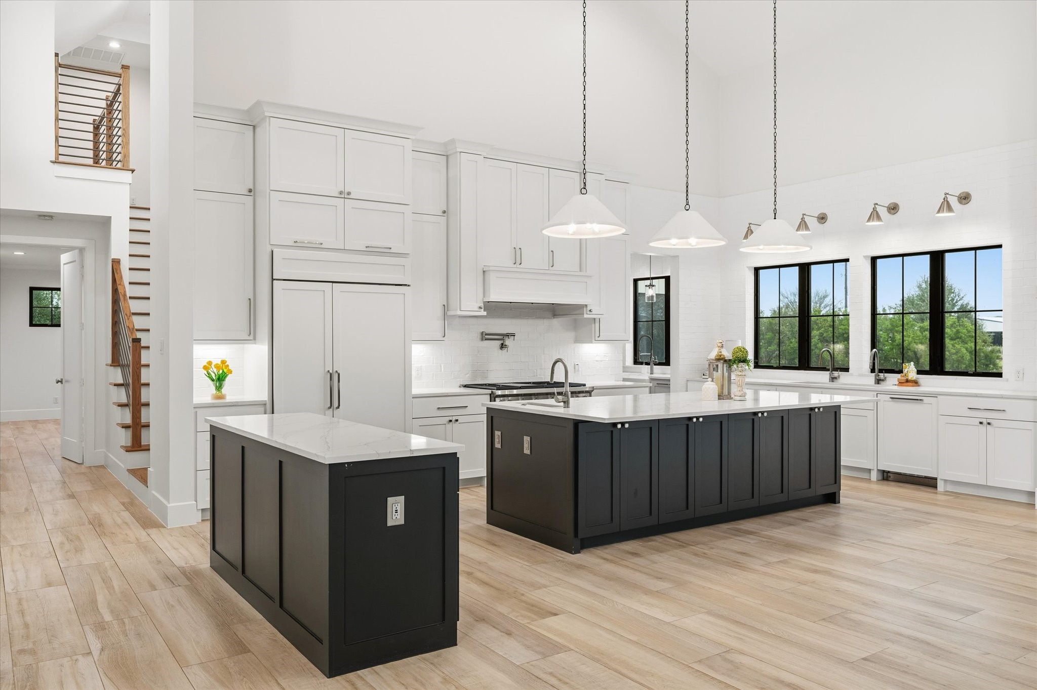 24118 Margerstadt Road Hockley, TX 77447 - Photo 13 of 50 The dual-island kitchen is outfitted with Viking and Wolf appliances, quartz countertops, and a butler’s pantry—offering a balance of luxury and efficiency in a bright, high-ceilinged layout.