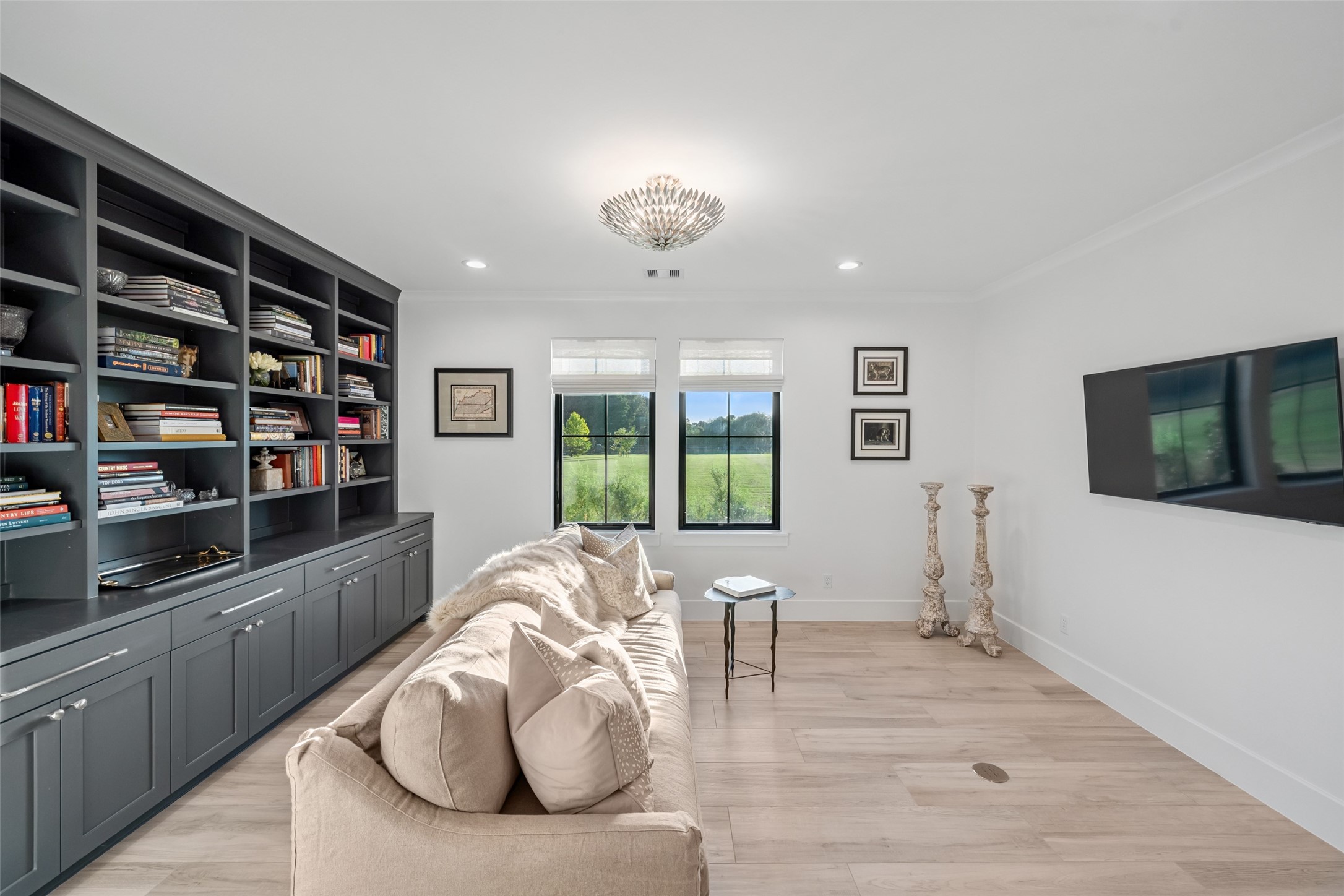 24118 Margerstadt Road Hockley, TX 77447 - Photo 16 of 50 Custom built-in bookcases, crown molding, and a closet define this versatile study, with recessed lighting creating a focused yet inviting space.