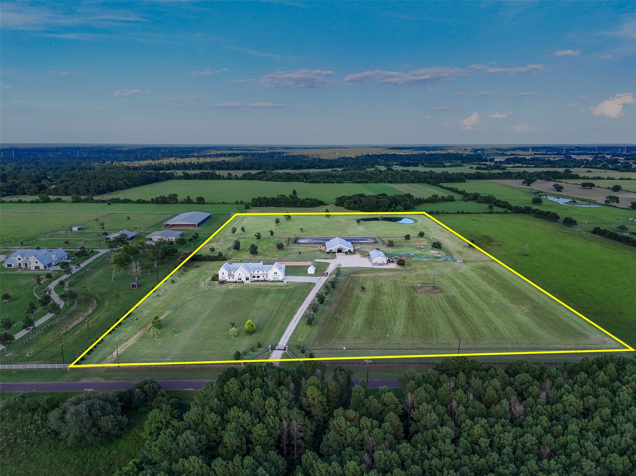 24118 Margerstadt Road Hockley, TX 77447 - Photo 2 of 50 Aerial overlay outlines the full 19-acre estate, showcasing the thoughtfully planned layout—complete with home, barn, arena, shop, paddocks, and multiple fenced pastures. Boundary lines are approximate and for illustrative purposes only; buyer to independently verify.