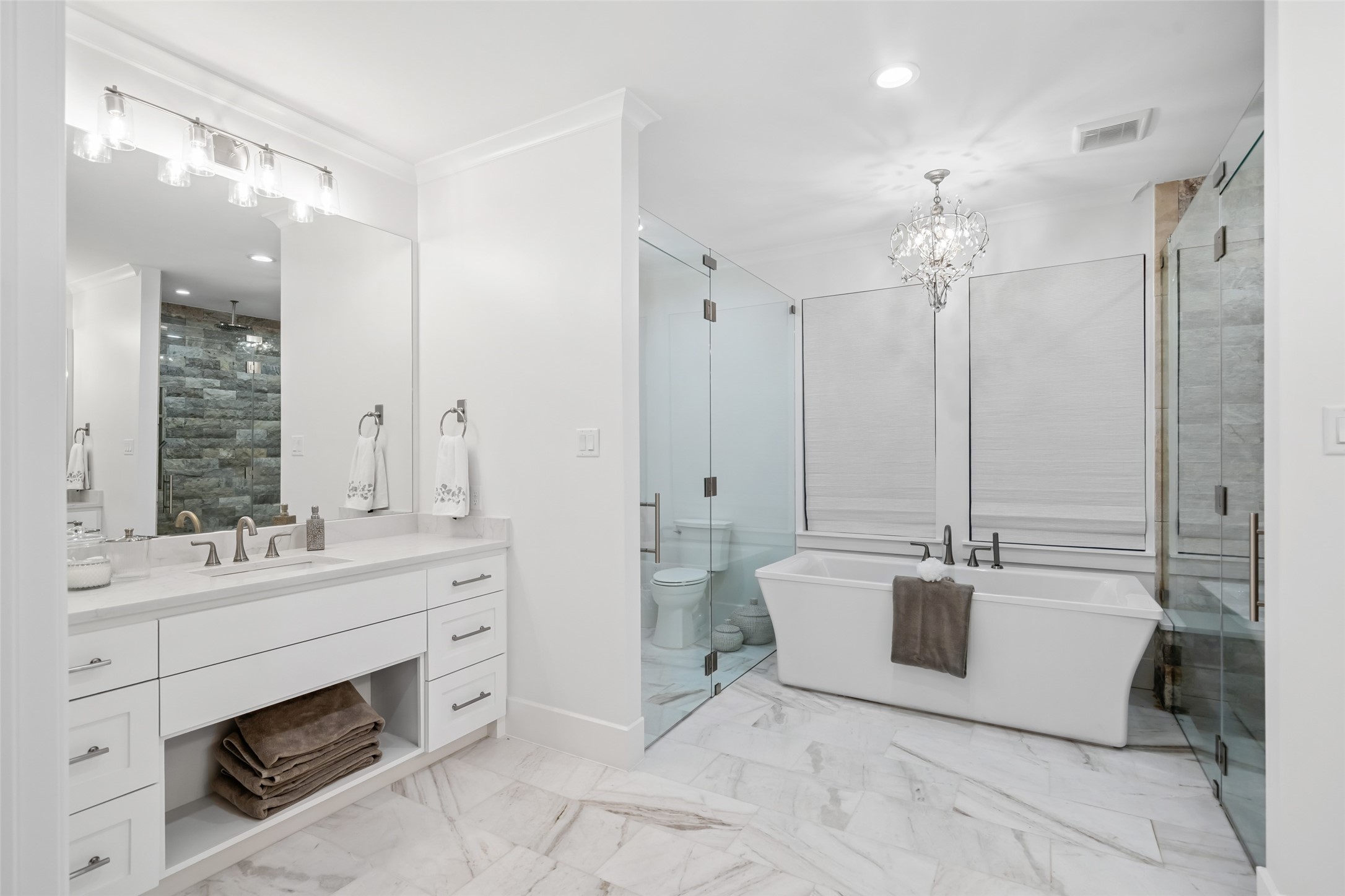 24118 Margerstadt Road Hockley, TX 77447 - Photo 21 of 50 Framed by matching vanities and thoughtful lighting, the bathroom layout offers both privacy and flow between the freestanding tub and the walk-in showers.
