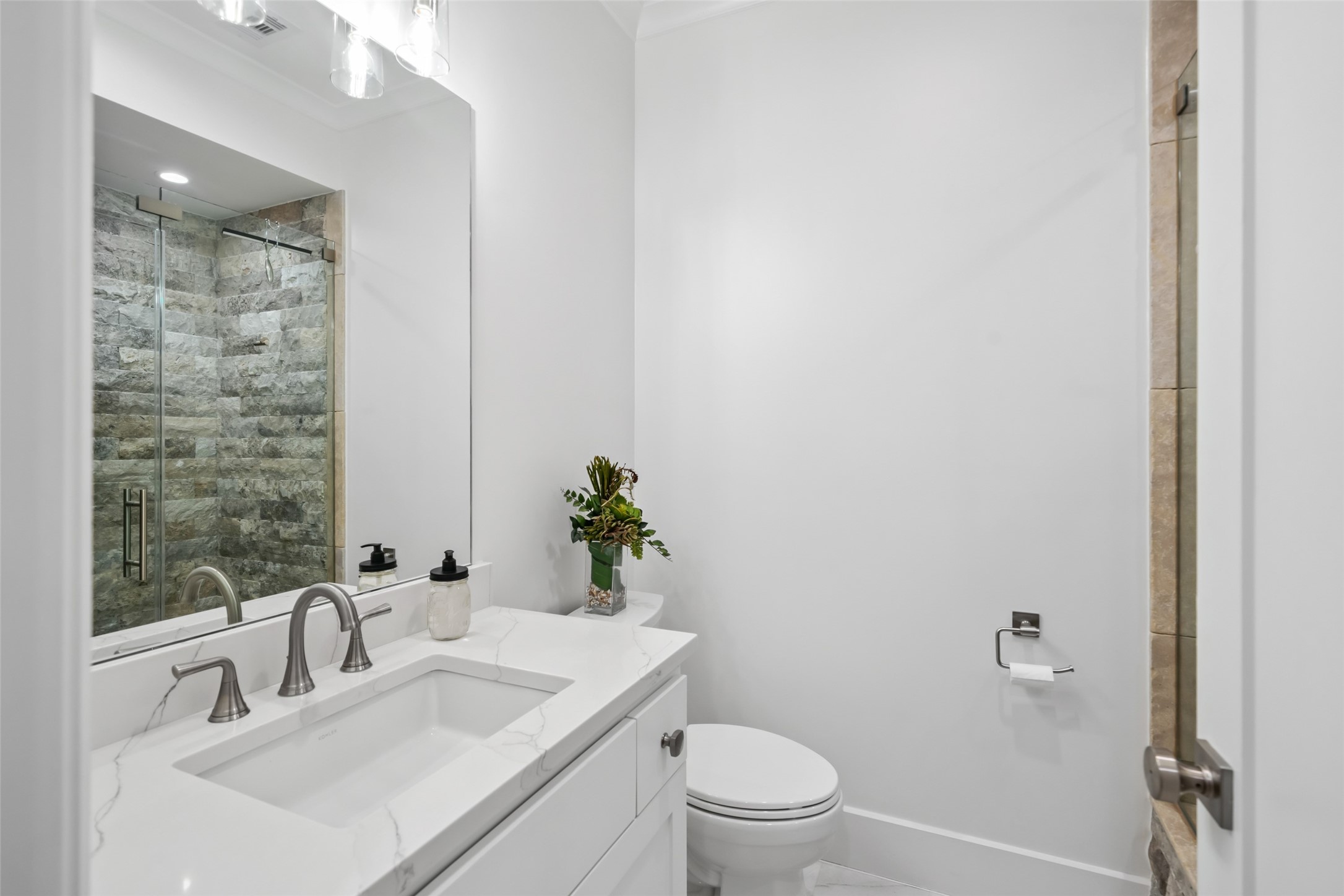 24118 Margerstadt Road Hockley, TX 77447 - Photo 23 of 50 A separate ensuite primary bath features a walk-in shower and modern vanity, complementing a dual-primary layout with convenience and privacy.