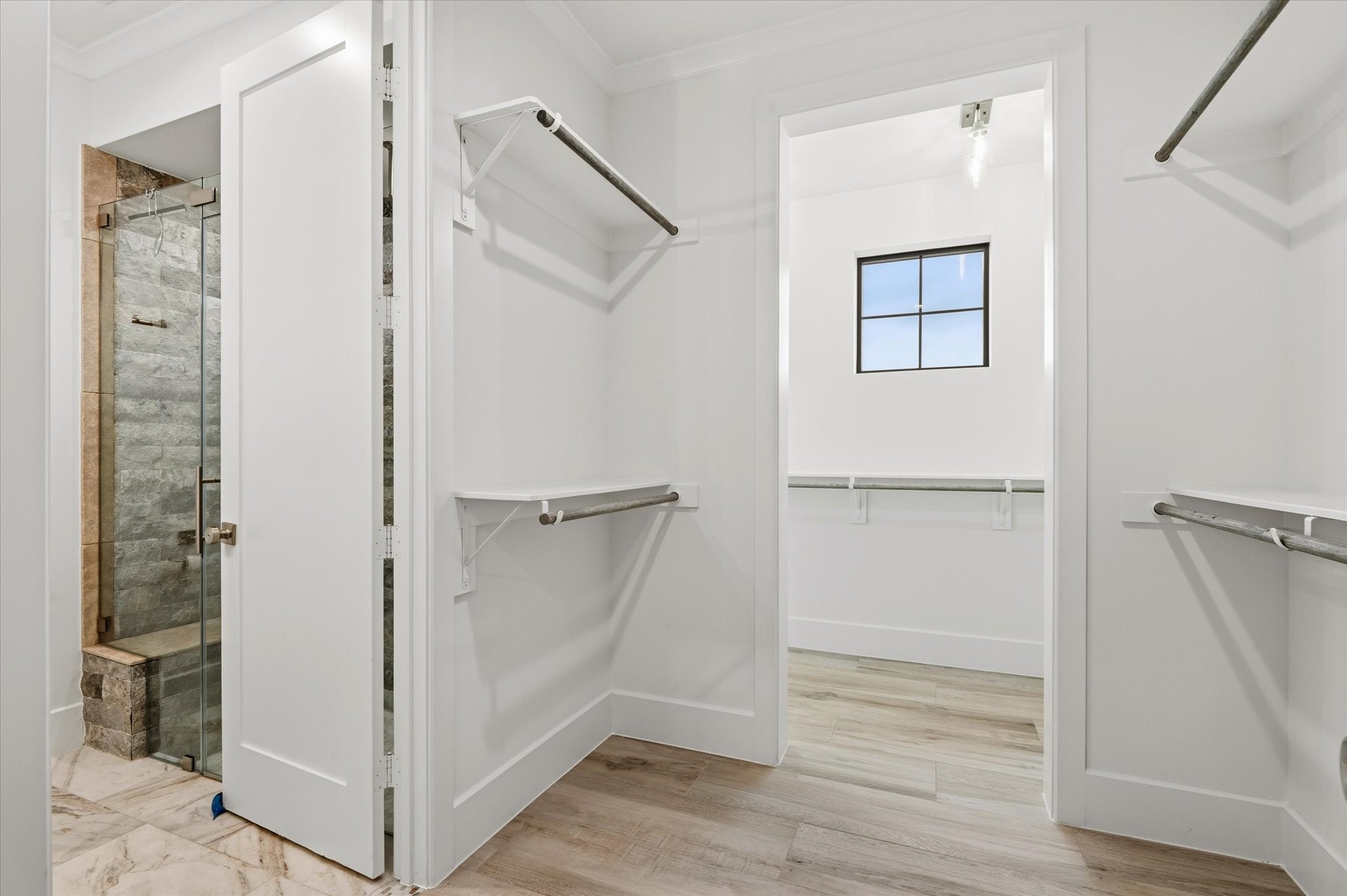 24118 Margerstadt Road Hockley, TX 77447 - Photo 24 of 50 Primary suite includes dual walk-in closets—this one offering thoughtful hanging space and natural light, just steps from the ensuite bath and shower.