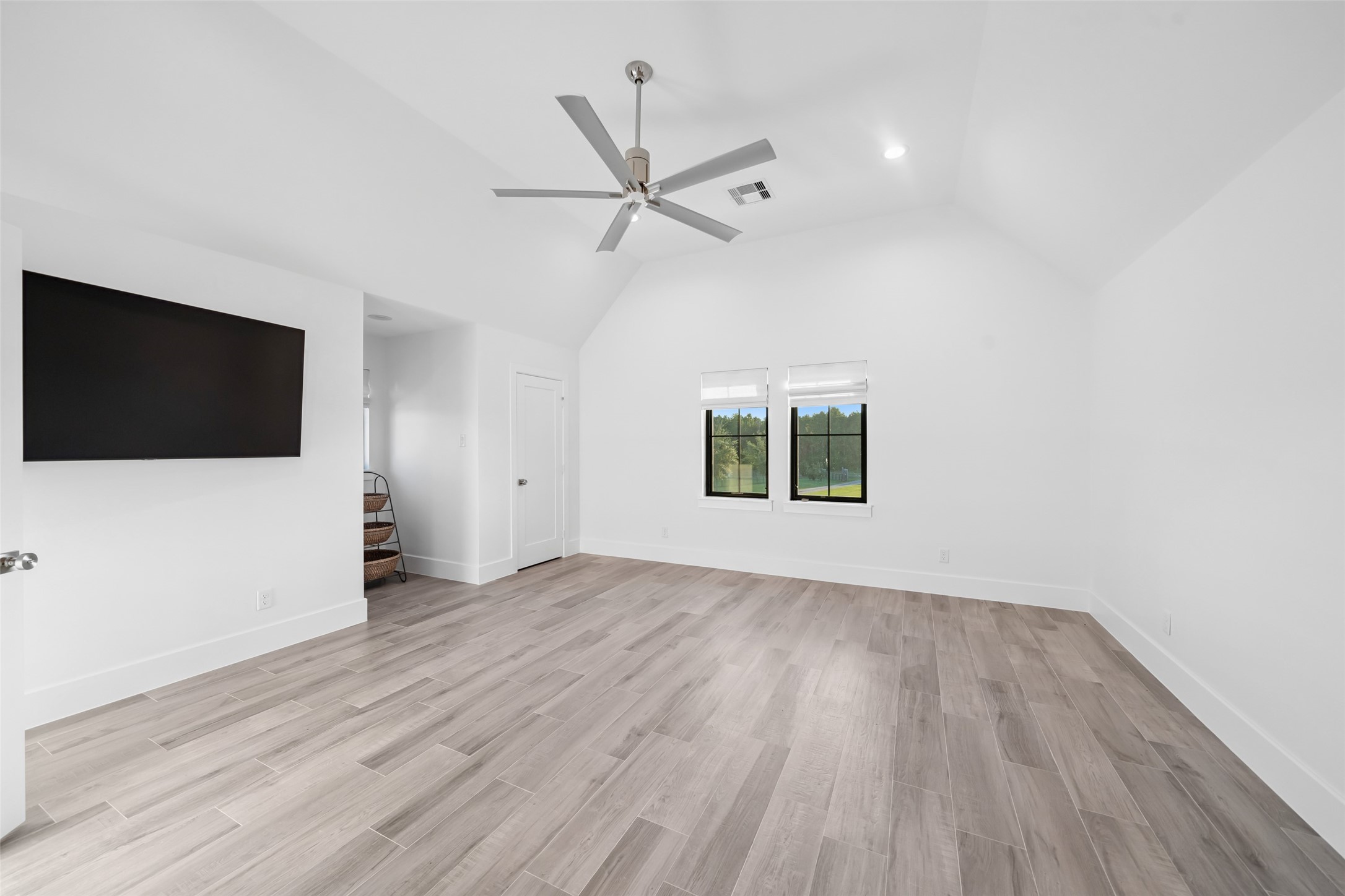 24118 Margerstadt Road Hockley, TX 77447 - Photo 30 of 50 Designed for comfort and versatility, this upstairs media retreat boasts soaring ceilings, sleek wood-look tile, and serene views—ideal for immersive entertainment, private screenings, or refined downtime.