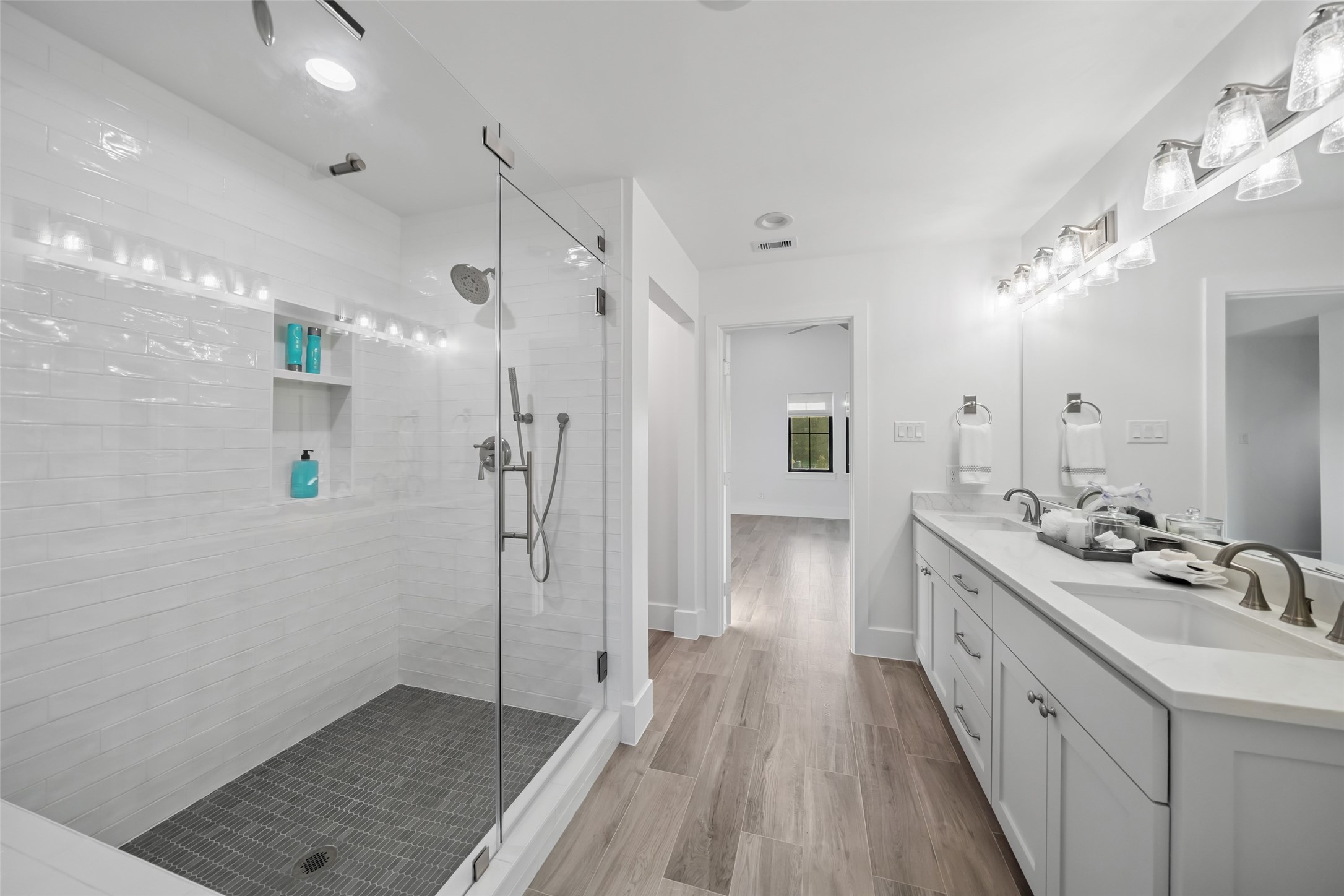 24118 Margerstadt Road Hockley, TX 77447 - Photo 31 of 50 Private ensuite bath features a walk-in shower, quartz vanity, and modern finishes—designed exclusively for the adjoining media room and bedroom.