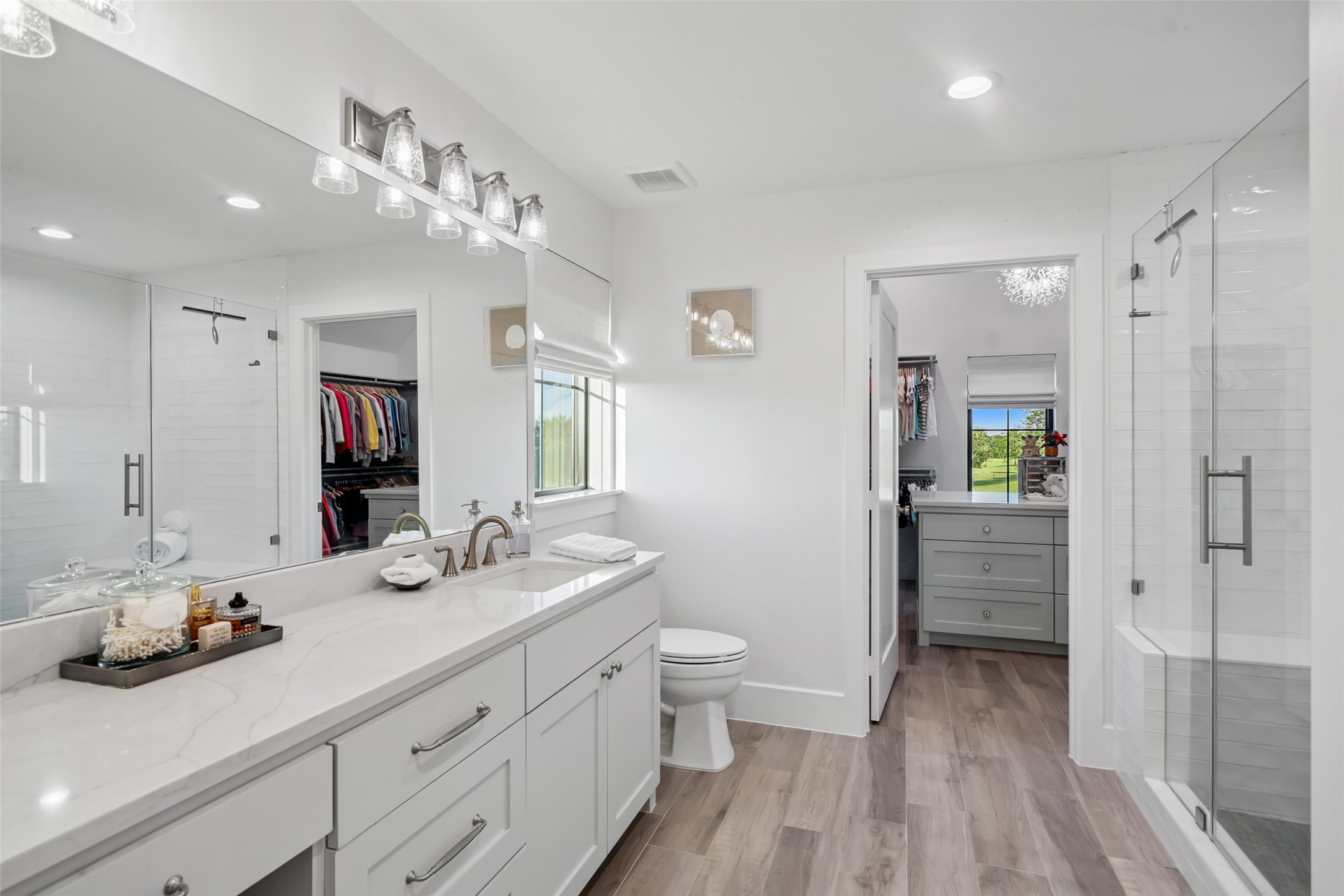 24118 Margerstadt Road Hockley, TX 77447 - Photo 32 of 50 A frameless glass shower and dual vanity create a polished ensuite experience, with direct access to both bedroom and a luxurious walk-in closet.