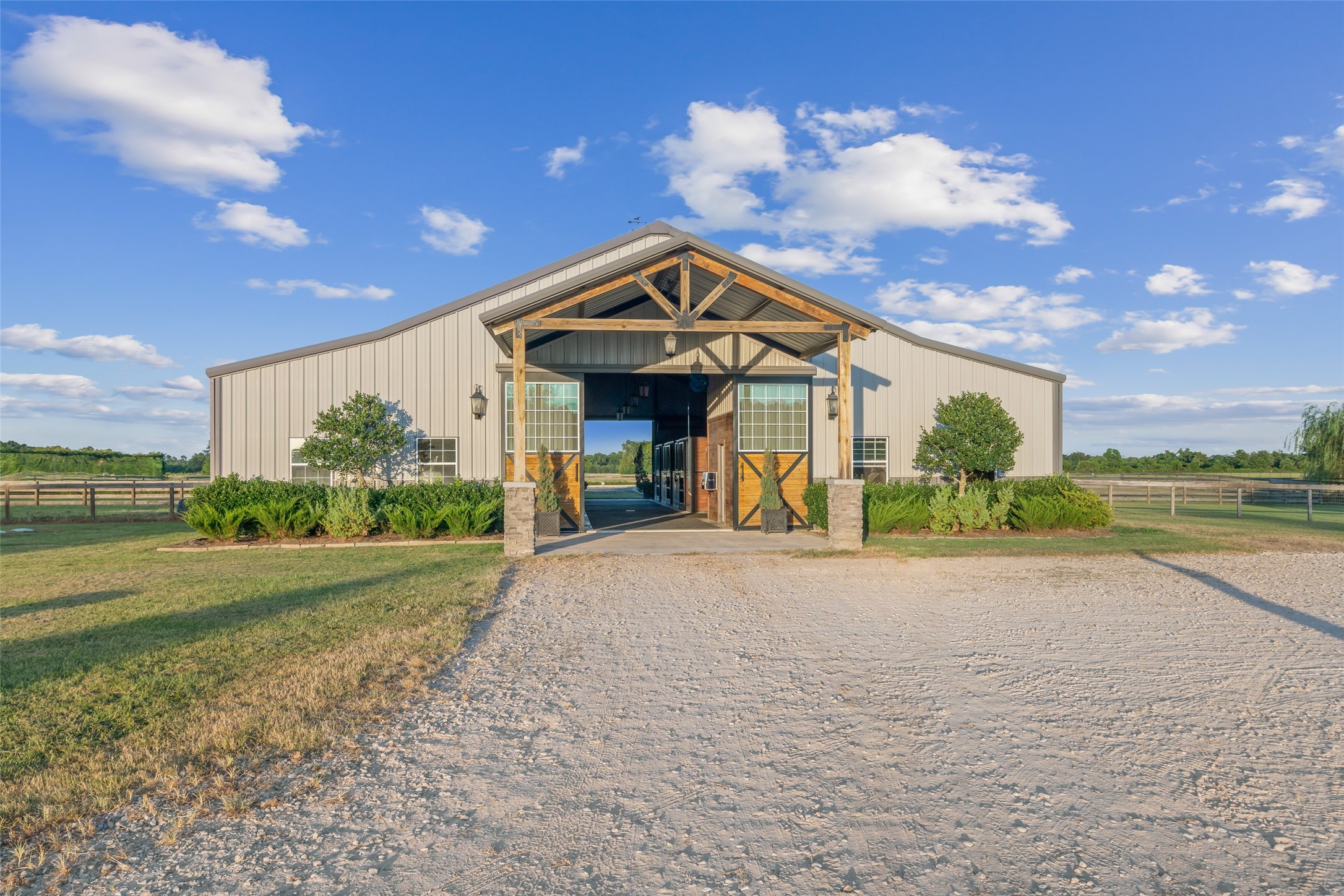 24118 Margerstadt Road Hockley, TX 77447 - Photo 38 of 50 The custom 70’ x 45’ barn welcomes with cross ventilation, large roll-up doors, and a clean architectural profile designed for performance and flow.