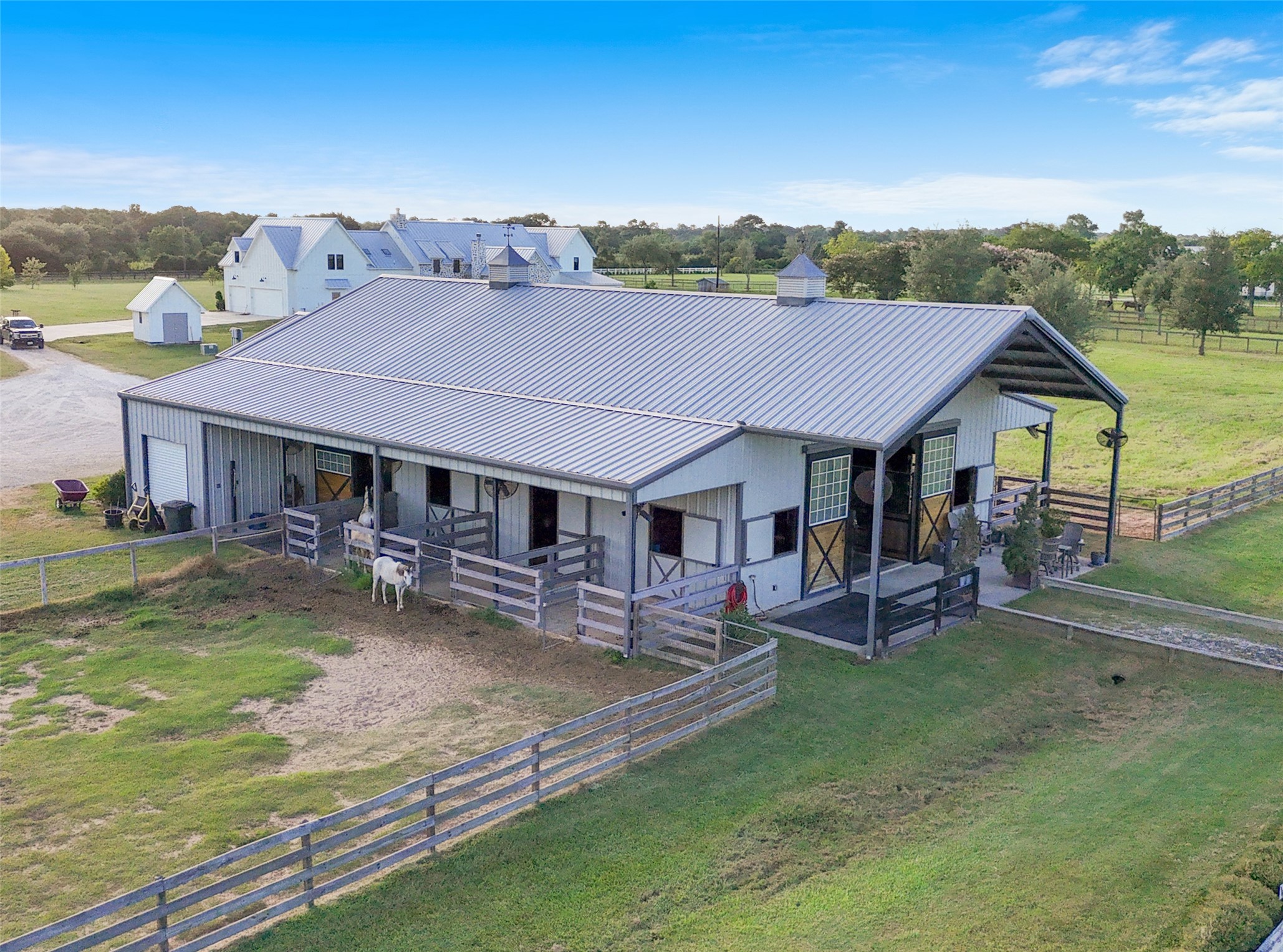 24118 Margerstadt Road Hockley, TX 77447 - Photo 39 of 50 Six 14x14 stalls with geo-grid runs and no-climb fencing open directly to the paddocks, offering both comfort and security for horses.