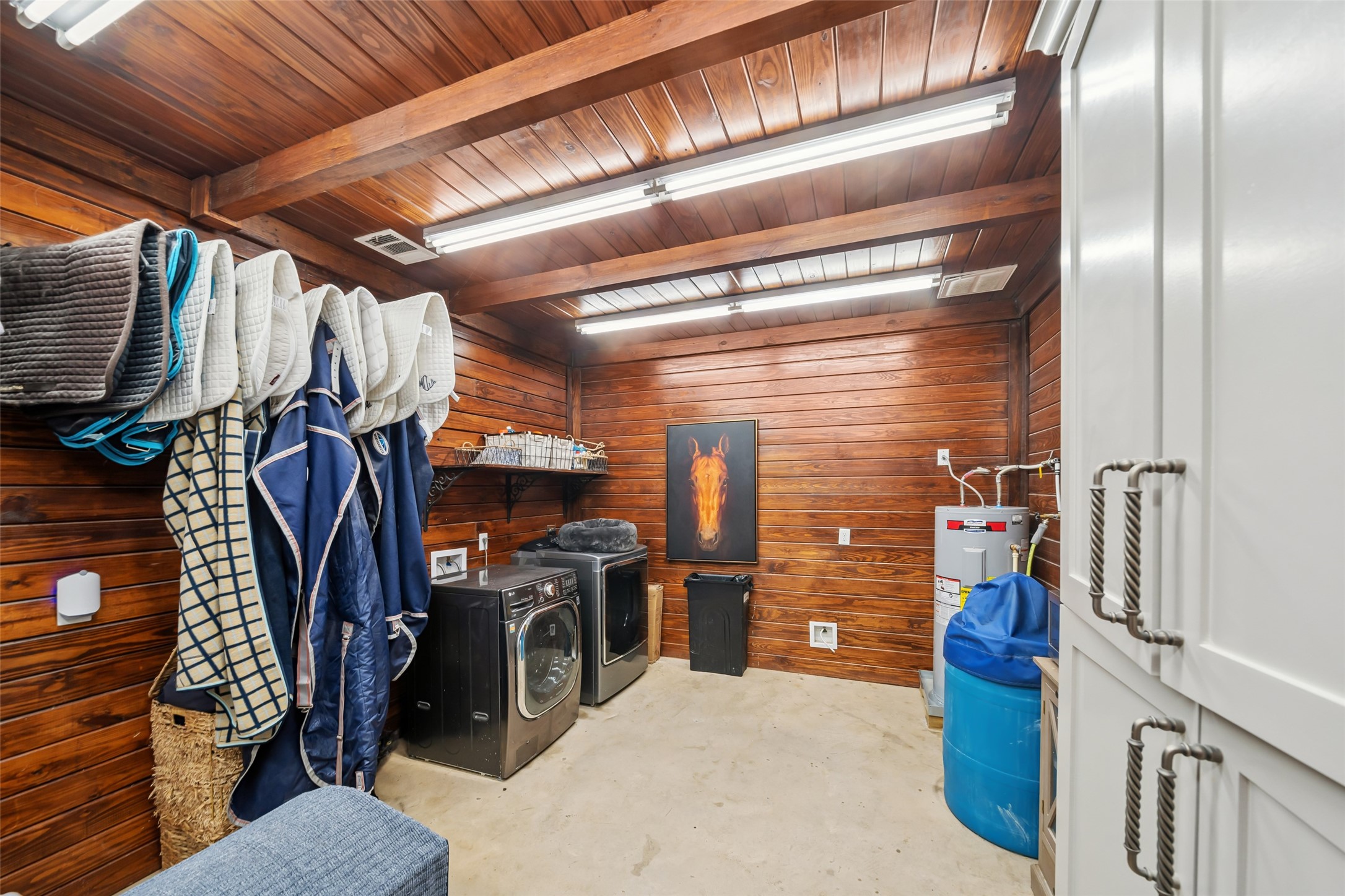 24118 Margerstadt Road Hockley, TX 77447 - Photo 41 of 50 A fully outfitted utility and laundry room inside the barn includes washer/dryer, water heater, and ample space for daily tasks or storage.