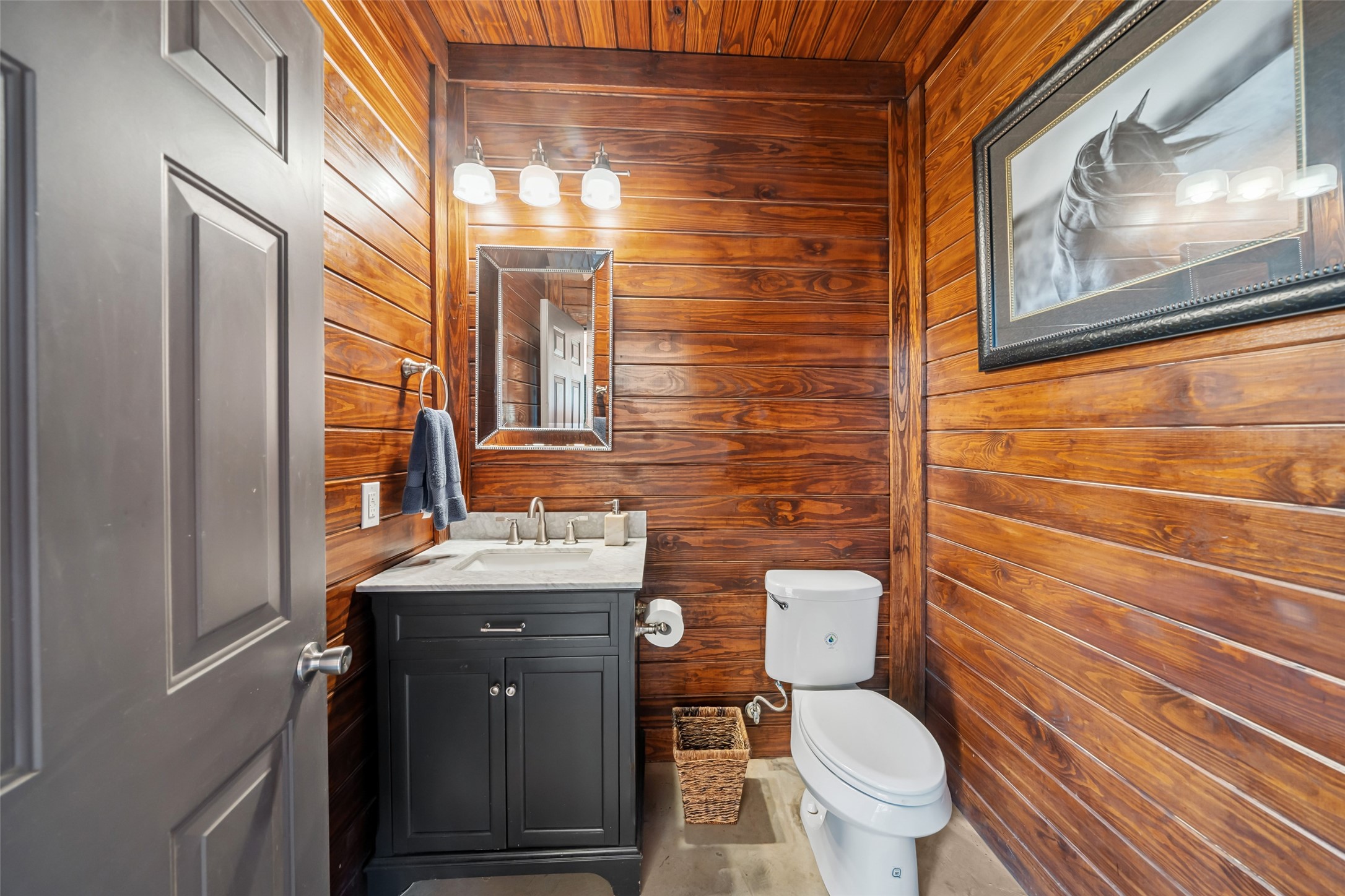 24118 Margerstadt Road Hockley, TX 77447 - Photo 42 of 50 The barn includes a finished half bath with warm wood paneling and modern fixtures—offering convenience without compromising style.