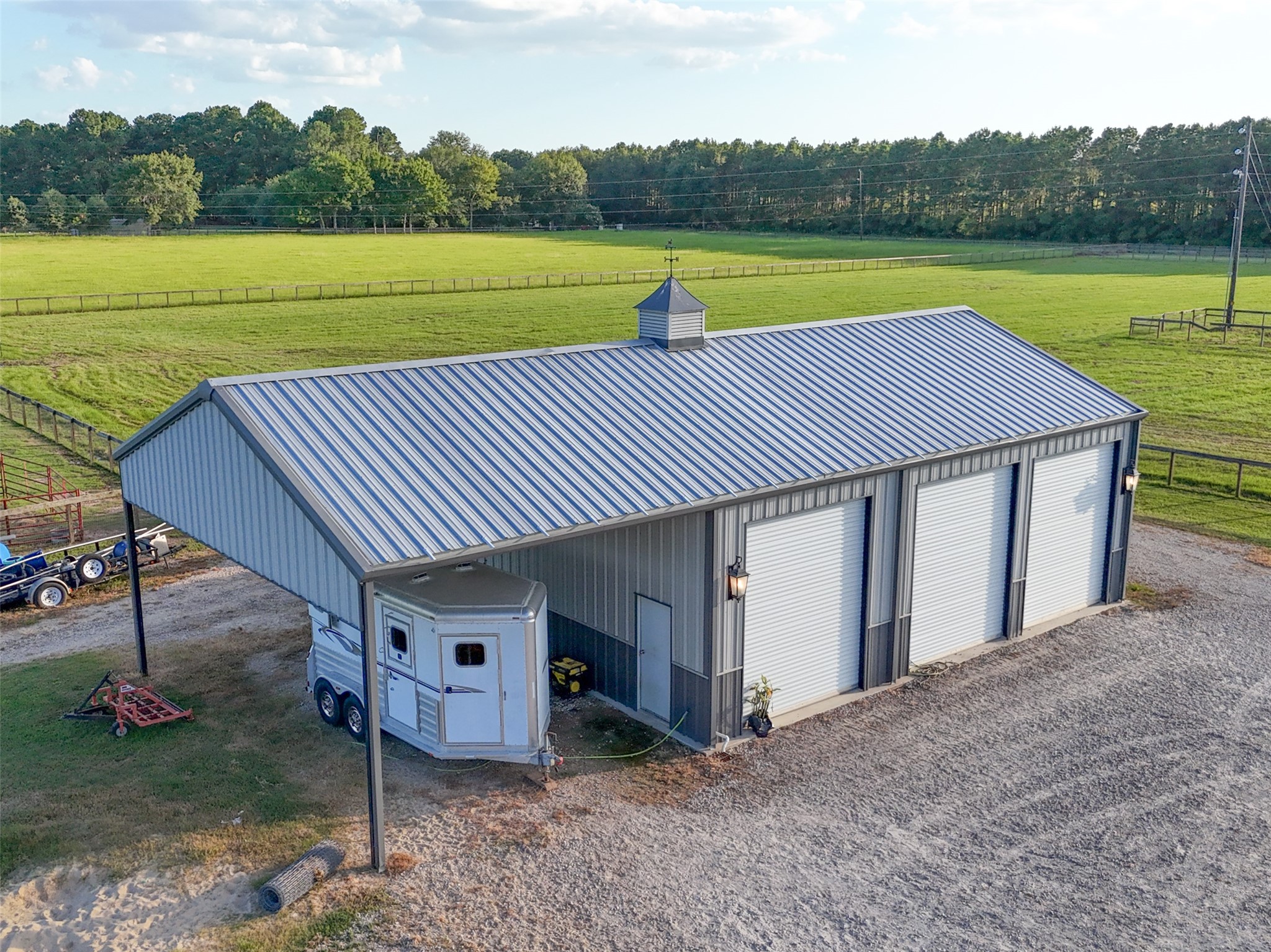 24118 Margerstadt Road Hockley, TX 77447 - Photo 47 of 50 This 1,200 sq ft insulated metal shop includes three roll-up doors and an overhang—designed for trailer parking, storage, or workshop use.