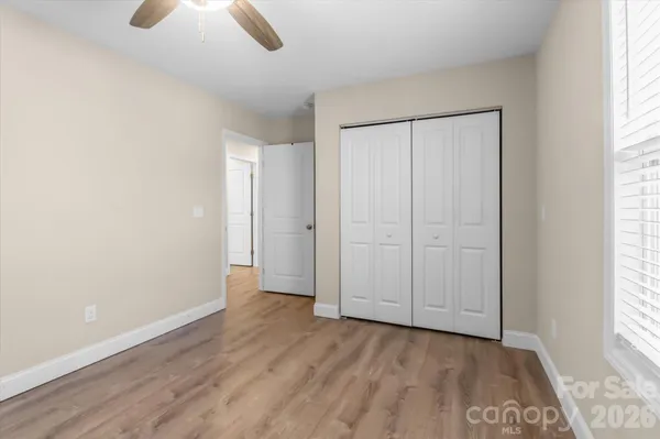 an empty room with windows and closet