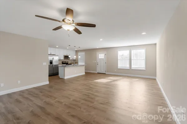 a view of a kitchen with a sink dishwasher refrigerator and window