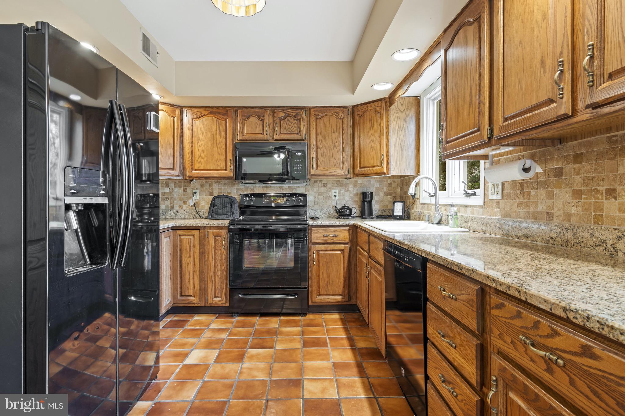 1 Derringdale Road Wayne, PA 19087 - Photo 23 of 41 Kitchen w/Gas Cooking and Window Overlooking Yard