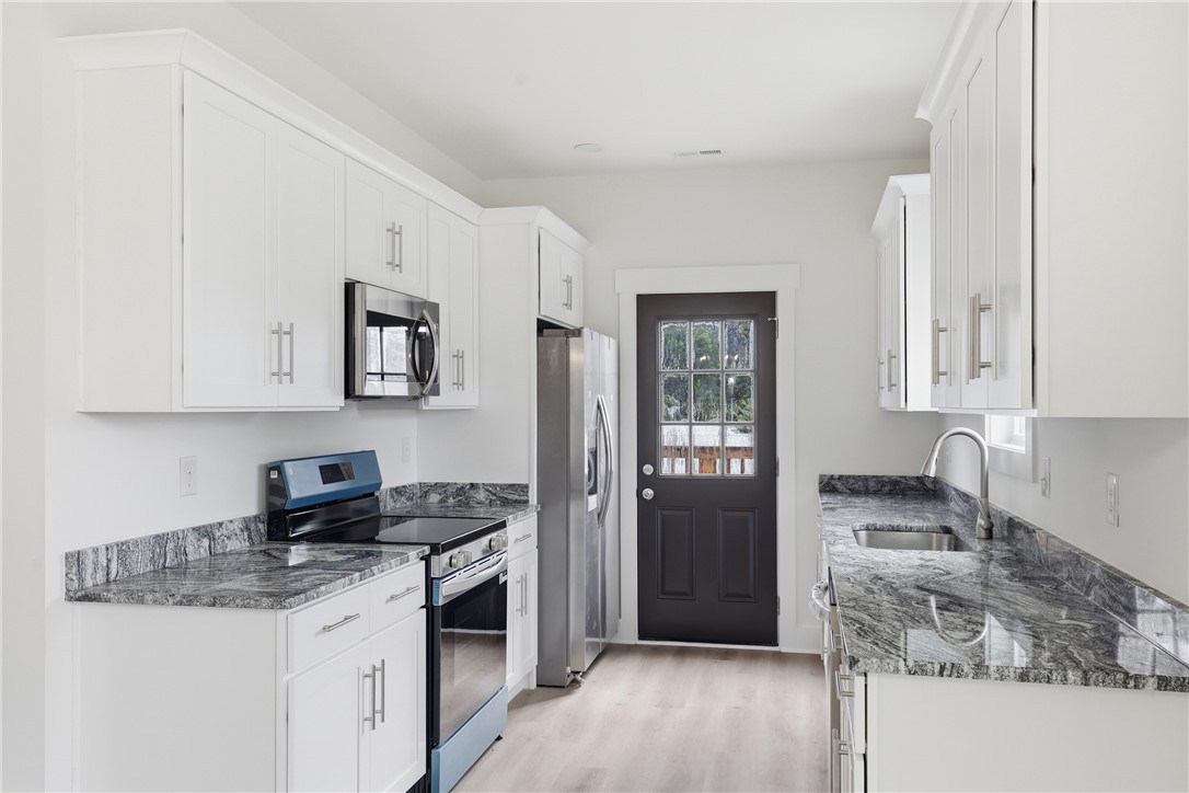 403 Tribble Street Seneca, SC 29678 - Photo 11 of 37 A well-appointed kitchen boasts sleek countertops and modern appliances, perfect for culinary endeavors.