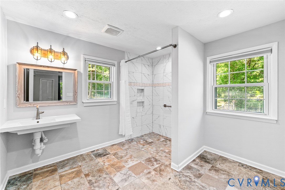 3815 Kingsland Road North Chesterfield, VA 23237 - Photo 16 of 40 a bathroom with a sink mirror and vanity