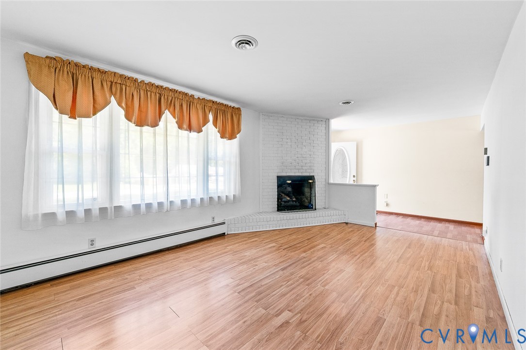 3815 Kingsland Road North Chesterfield, VA 23237 - Photo 5 of 40 a view of an empty room with wooden floor and a window