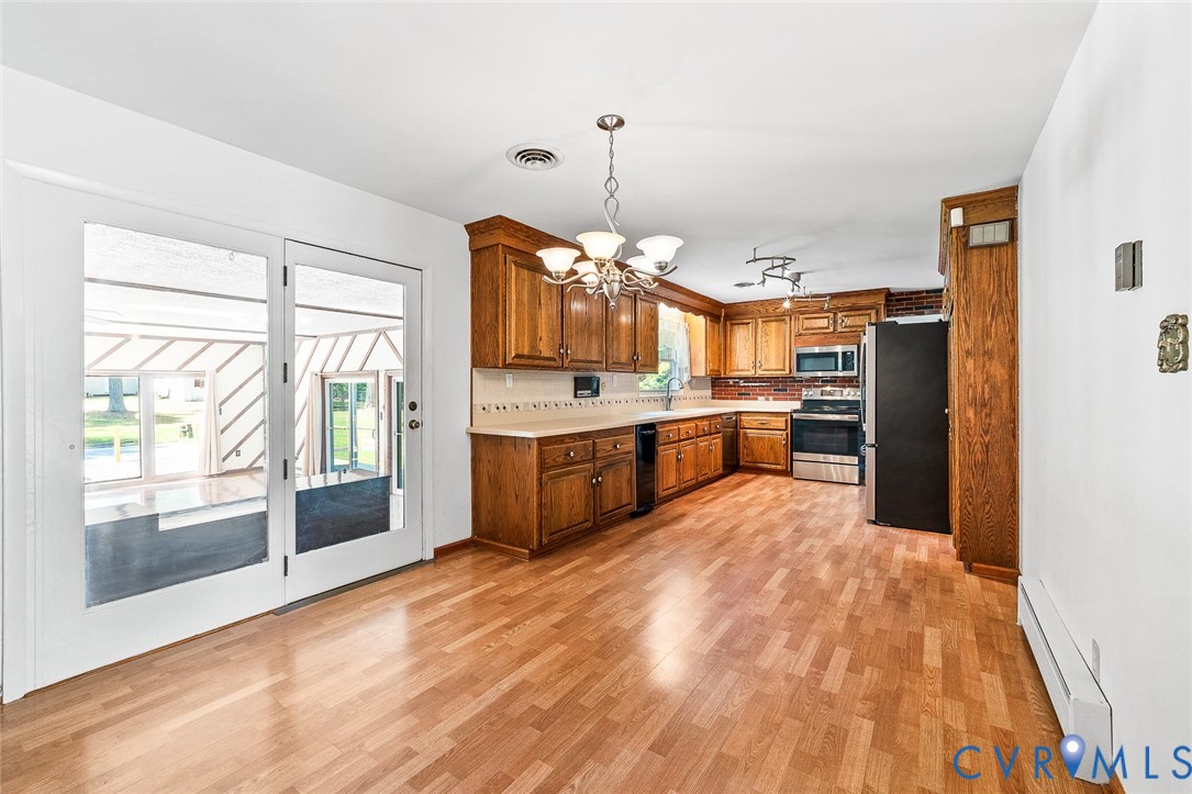 3815 Kingsland Road North Chesterfield, VA 23237 - Photo 8 of 40 a large kitchen with a window and stainless steel appliances