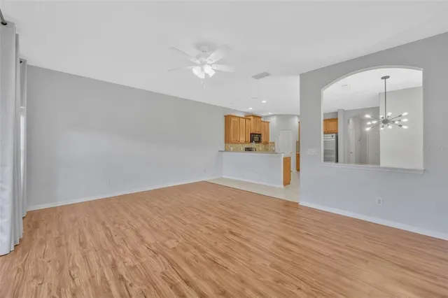 an empty room with wooden floor and mirror