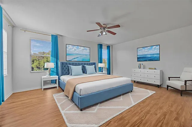 a bedroom with a bed wooden floor and window
