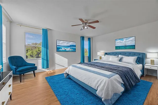 a spacious bedroom with a bed and wooden chair