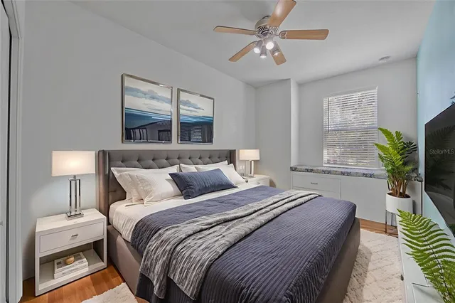 a bedroom with bed and a chandelier