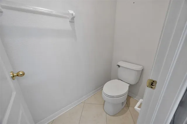 a white toilet sitting next to a window