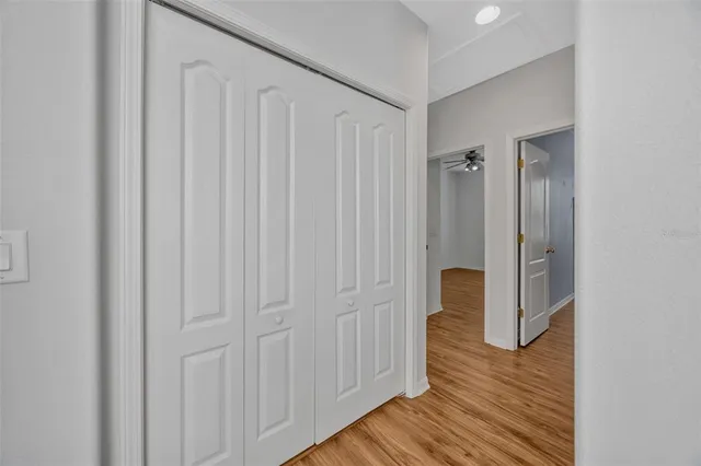a view of a hallway with wooden floor and staircase