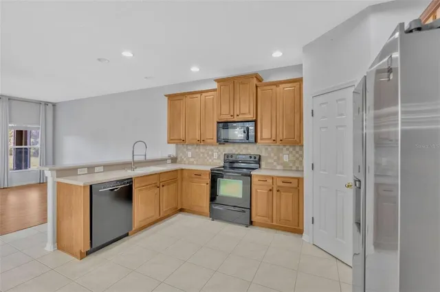 a kitchen with a sink stove and refrigerator