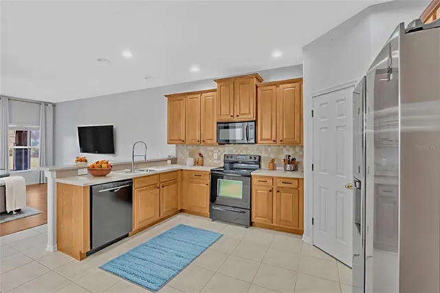 a kitchen with cabinets and stainless steel appliances