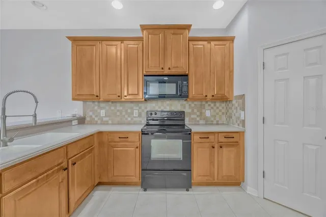 a kitchen with granite countertop cabinets stainless steel appliances and a sink