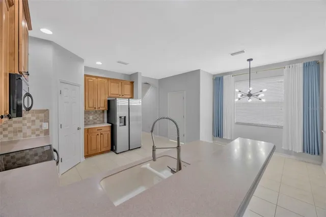 a room with a sink and chandelier