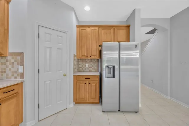 a metallic refrigerator freezer sitting in a kitchen