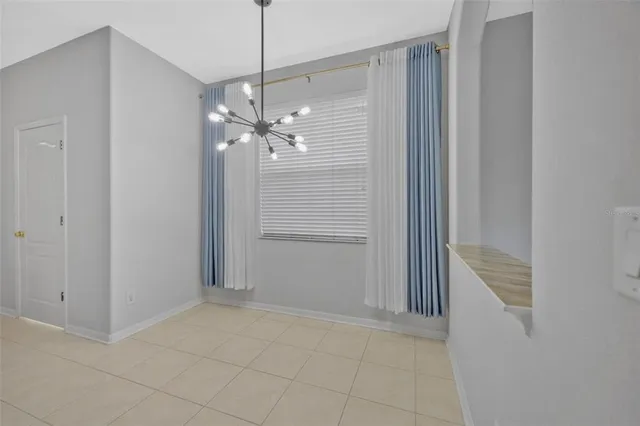 a view of a chandelier in big room and chandelier fan