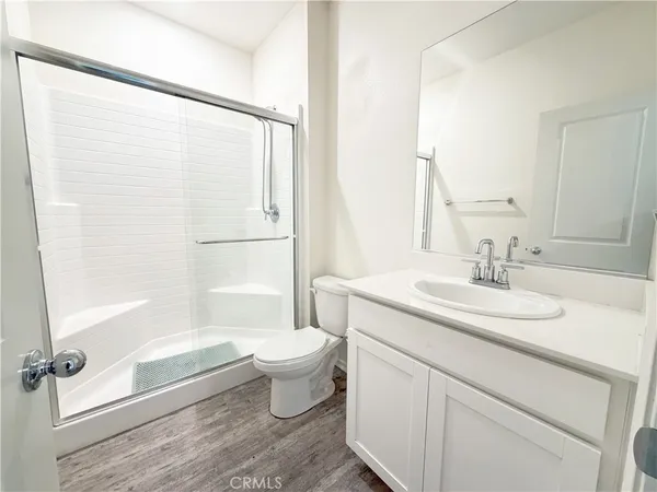 a bathroom with a sink toilet a mirror and shower