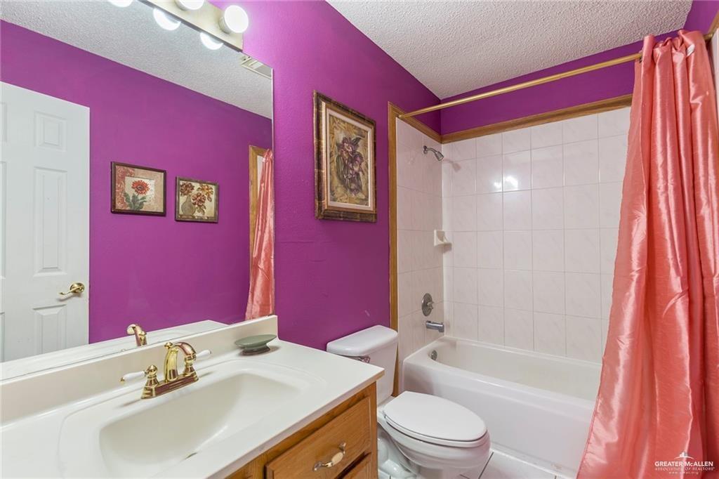 1801 Crown Pointe Boulevard Mission, TX 78572 - Photo 13 of 19 a bathroom with a sink a toilet a tub and shower