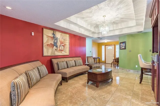 a living room with furniture and a chandelier