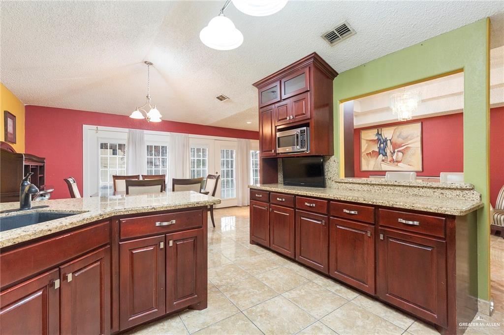 1801 Crown Pointe Boulevard Mission, TX 78572 - Photo 7 of 19 a kitchen with granite countertop a sink and cabinets