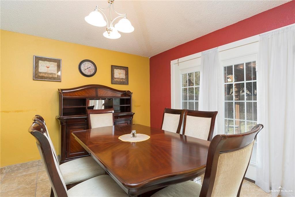 1801 Crown Pointe Boulevard Mission, TX 78572 - Photo 8 of 19 a view of a dining room with furniture and chandelier