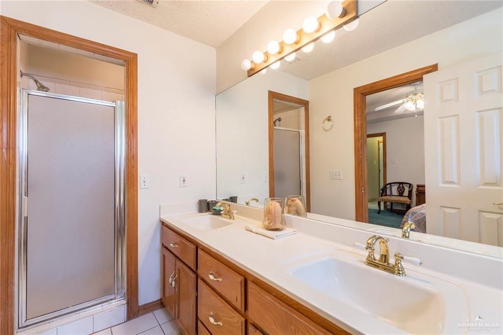 1801 Crown Pointe Boulevard Mission, TX 78572 - Photo 10 of 19 a bathroom with a double vanity sink and mirror