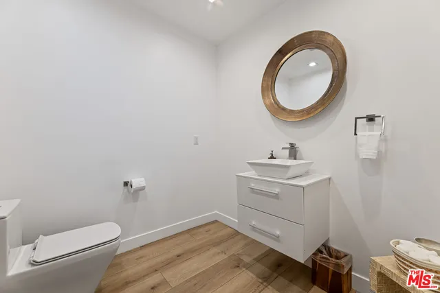 a bathroom with a sink a toilet and a mirror